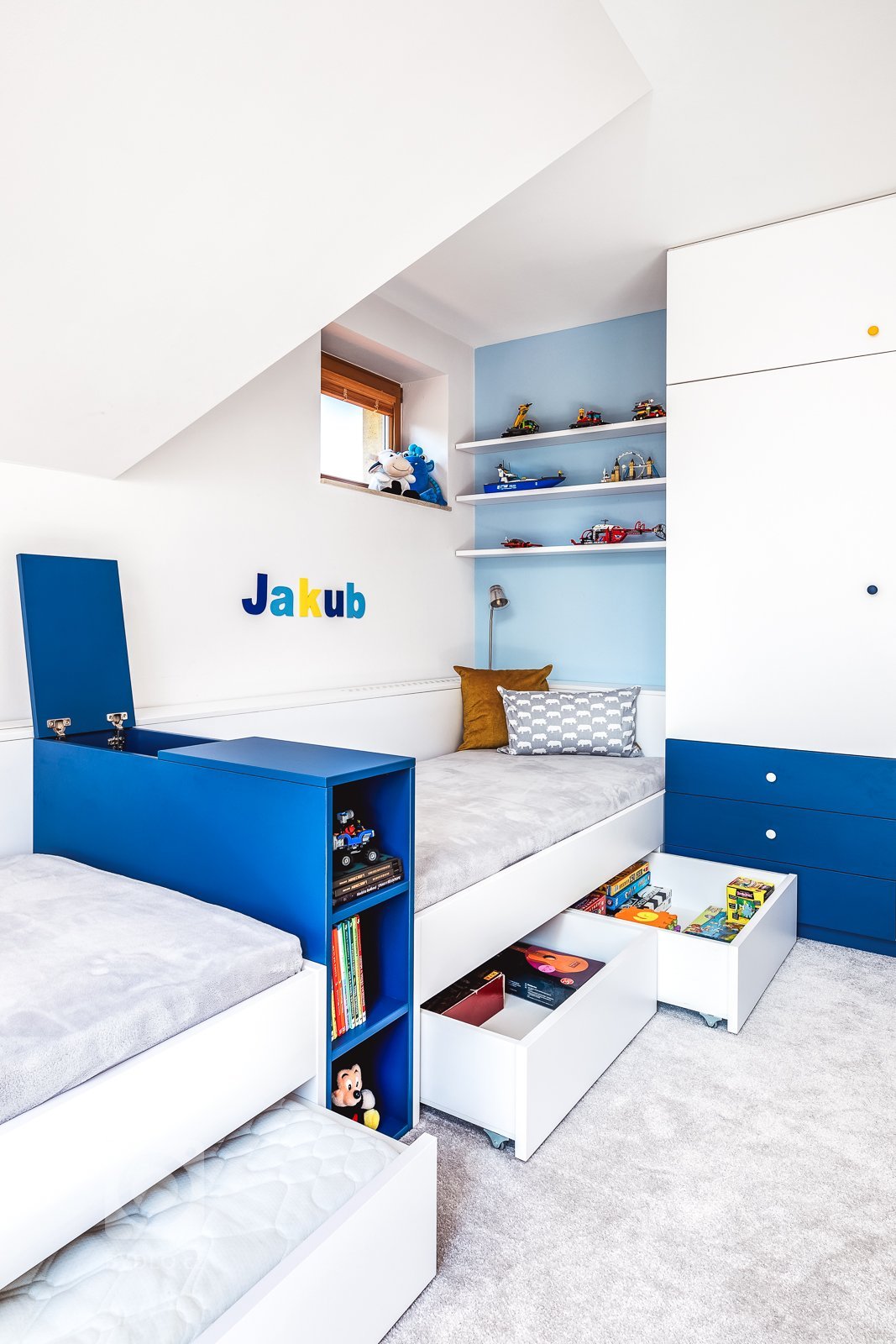 Jak do malého pokoje s atypickými rozměry vměstnat vše, co potřebují dva školáci? Místo na spaní, učení, hraní, úložný prostor, knihovnu a ještě jednu postel…