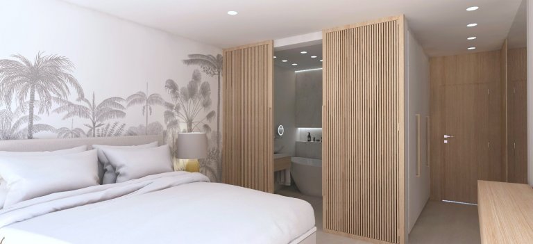 Návrh prázdninového apartmánu ve slunné Andalusii. Posuvná stěna z dřevěných lamel odděluje koupelnu s dvěma umyvadly a volně stojící vanou. Ložnice disponuje…