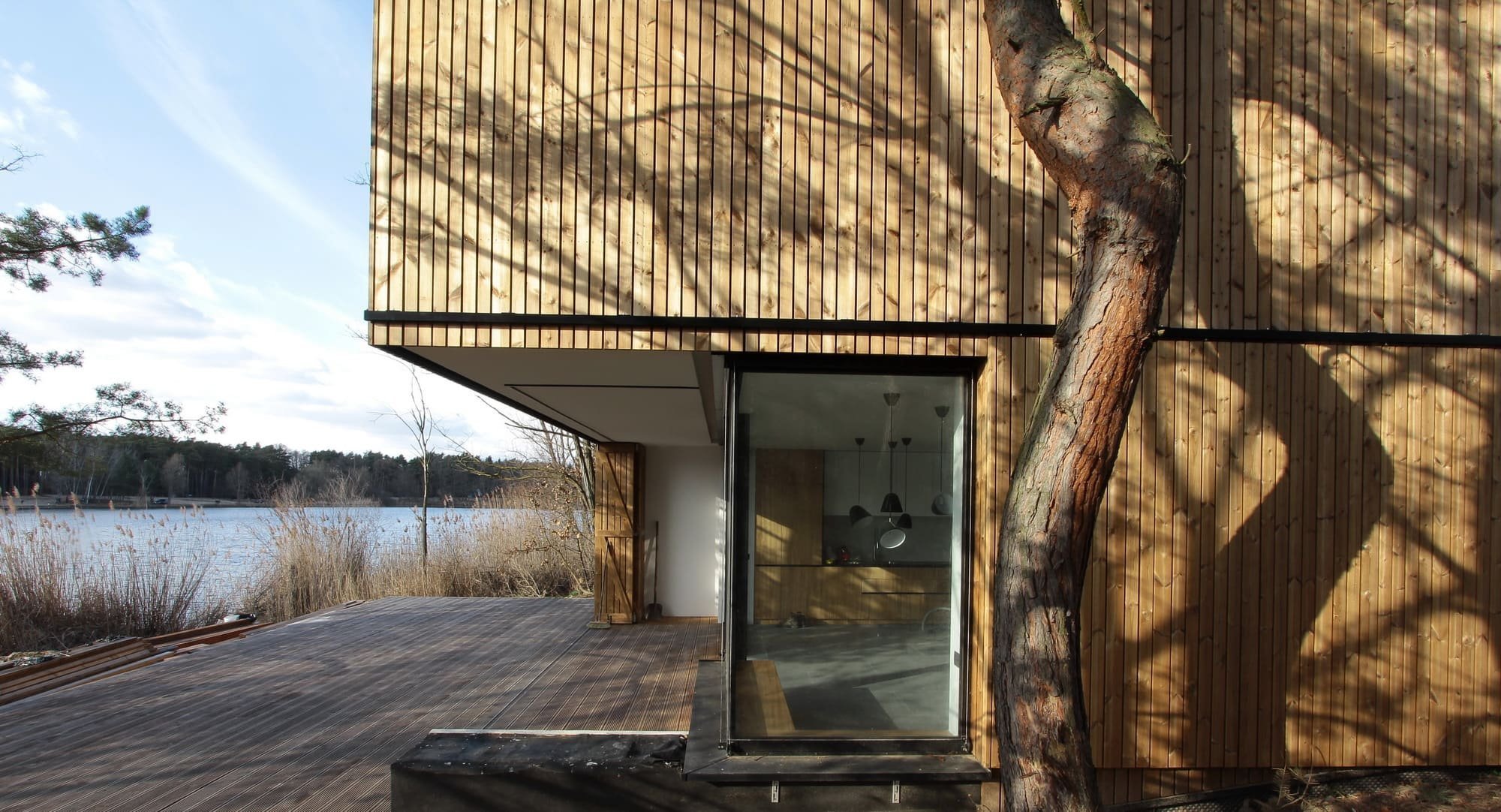 Chata v borovicovém lese na břehu jezera