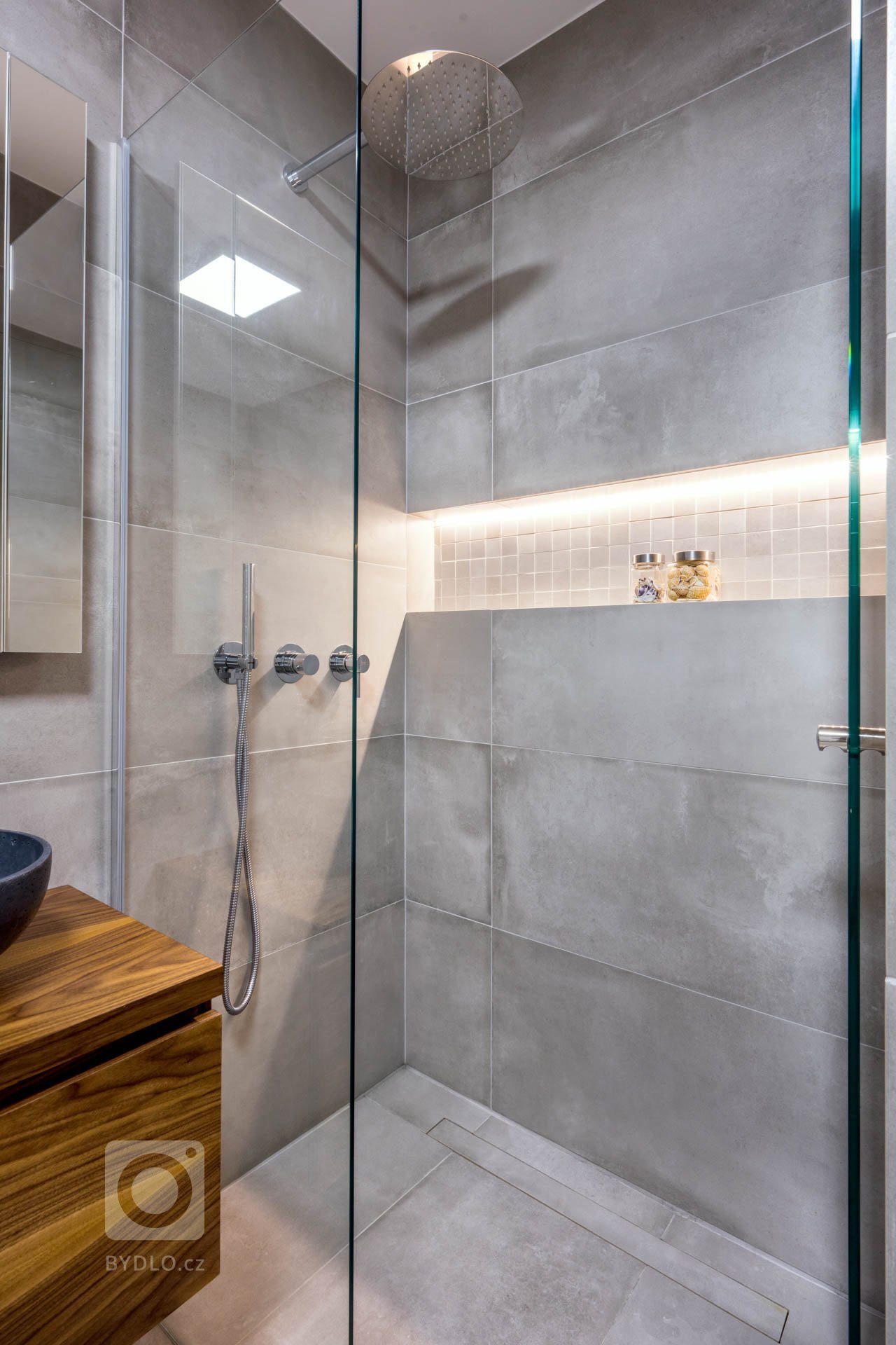 Šedá na obkladech, které imitují beton, podtrhla zvolený styl: industrialismus