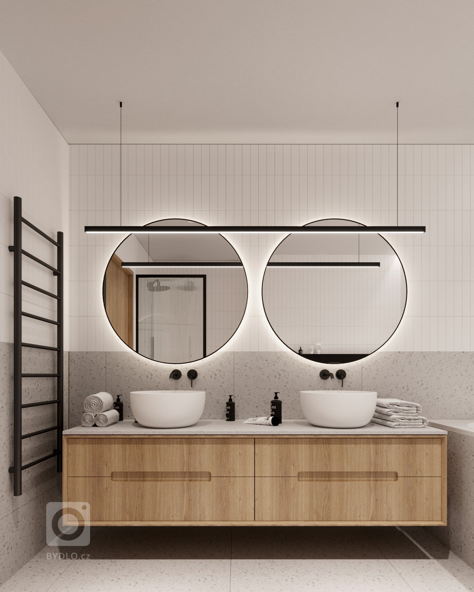 Použití terrazza v koupelnách zažívá velký boom. Dostupné jsou nejrůznější barevné varianty, kombinace a textury. My jsme se rozhodli pro velkoformátovou dlažbu právě s motivem terrazza v jemné barevné paletě. Prostor oživují černé matné detaily v podobě podomítkových baterií, svítidel a žebříkového radiátoru.