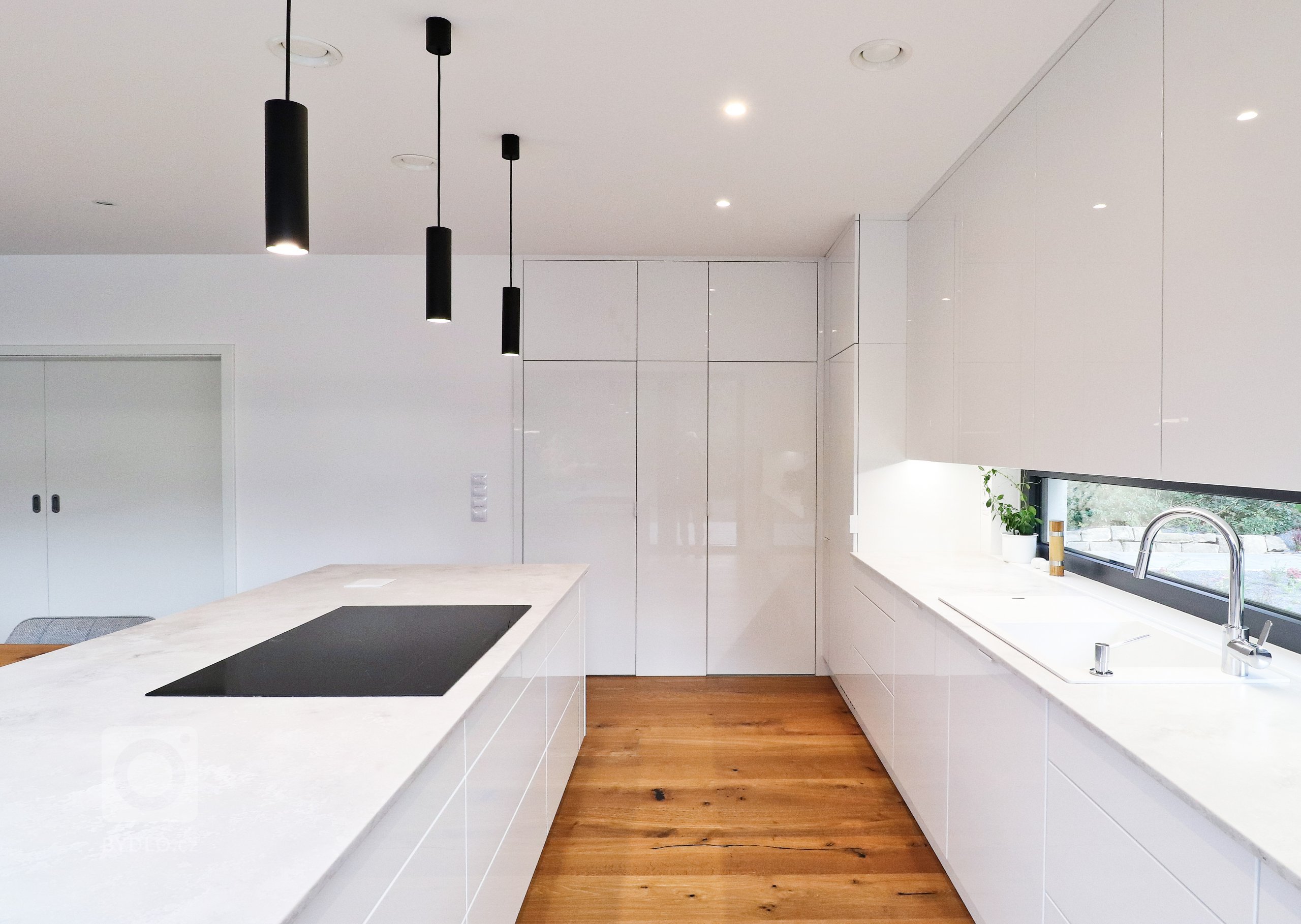 Této kuchyňské lince v&nbsp;Řeži u Prahy bílá prostě sluší.

Lesklý lak v&nbsp;kombinaci s&nbsp;pracovní deskou Technistone působí velmi elegantním a čistým…