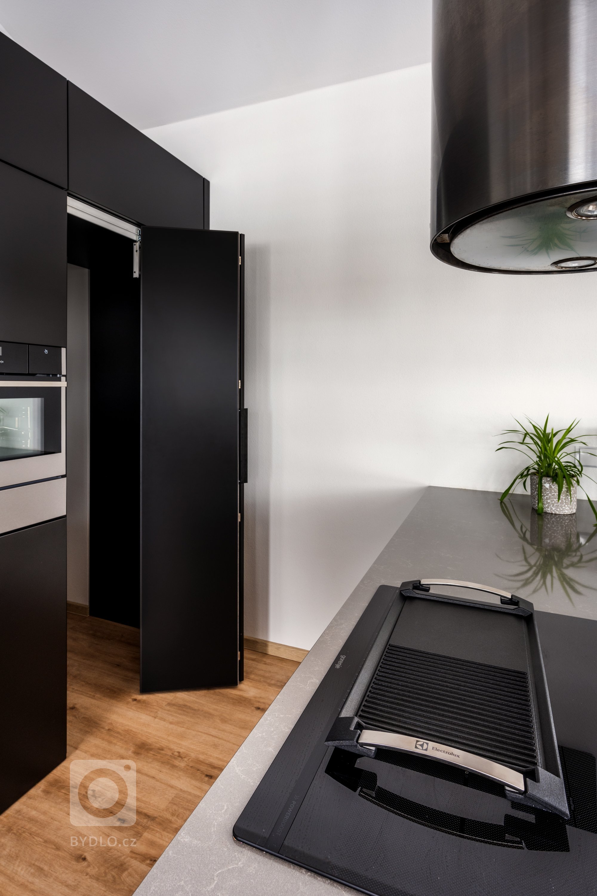 Speciální vychytávkou je tajná místnost v rohu. Má lomená dvířka, za nimiž se skrývá množství úložného místa, s mimořádně pohodlným vstupem a ergonomií. Můžete zde mít tyčový vysavač i extra rodinné balení ovesných vloček - cokoli je potřeba, je tady.